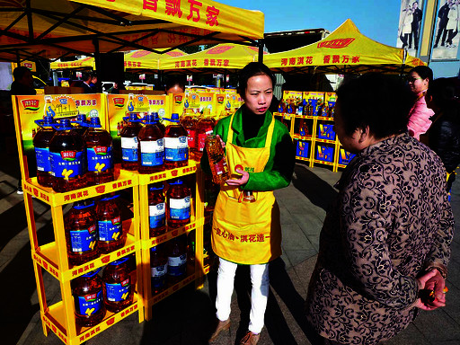 销售人员向市民介绍淇花食用油